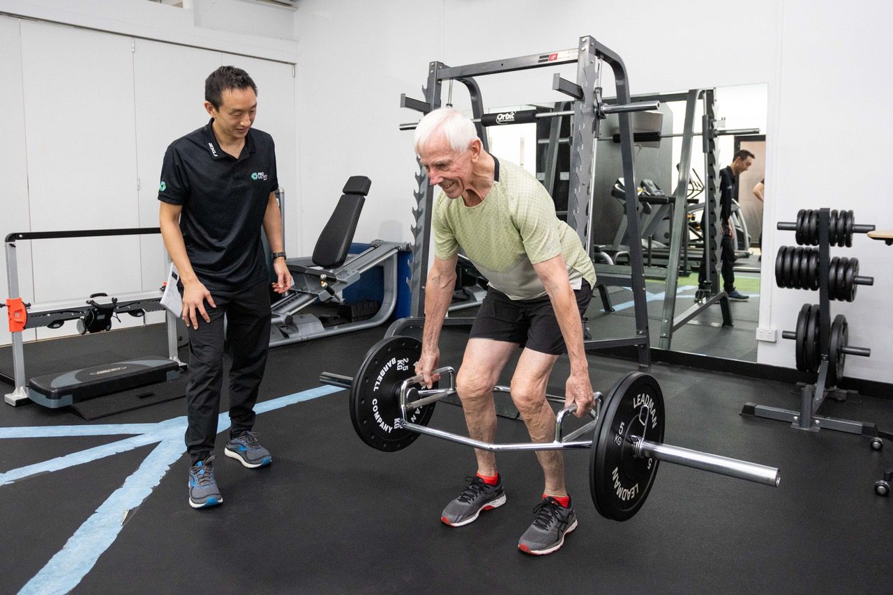 Old man lifting weight for low back pain